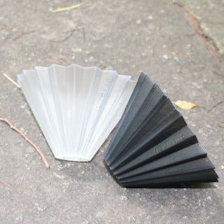 A clear and a black small ORIGAMI Dripper Air  on ground