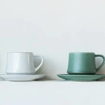 Two sets of ORIGAMI Flare Cups and Saucers, in vintage white and vintage green colors