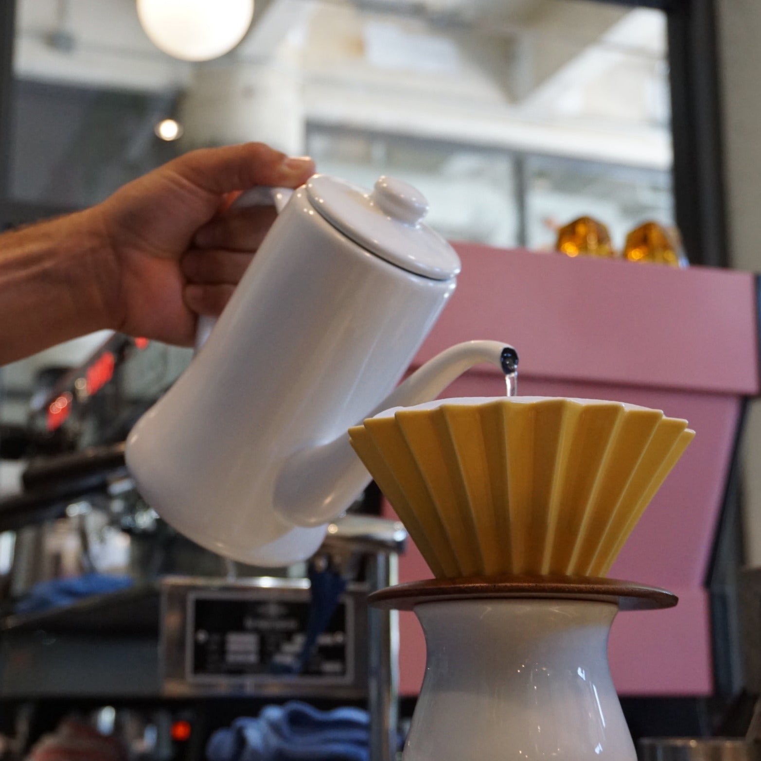 Making pour over coffee using yellow ORIGAMI Coffee Dripper and ORIGAMI Wood Dripper Holder