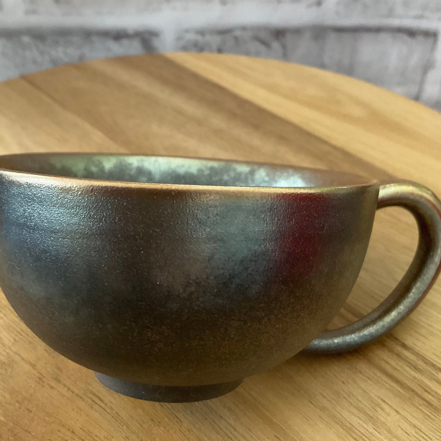 Side View of the Green-Golden Wood-Fired Ceramic Latte Cup