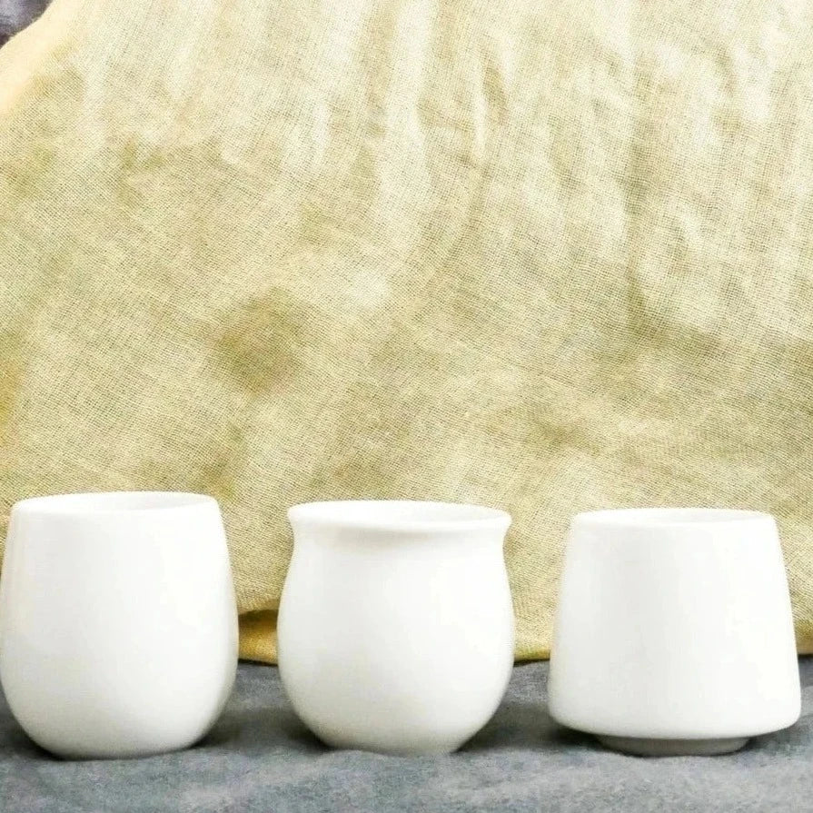 Three white ORIGAMI Barrel Aroma Flavor Cup, Pinot Flavor Cup and Aroma Flavor Cup in a row