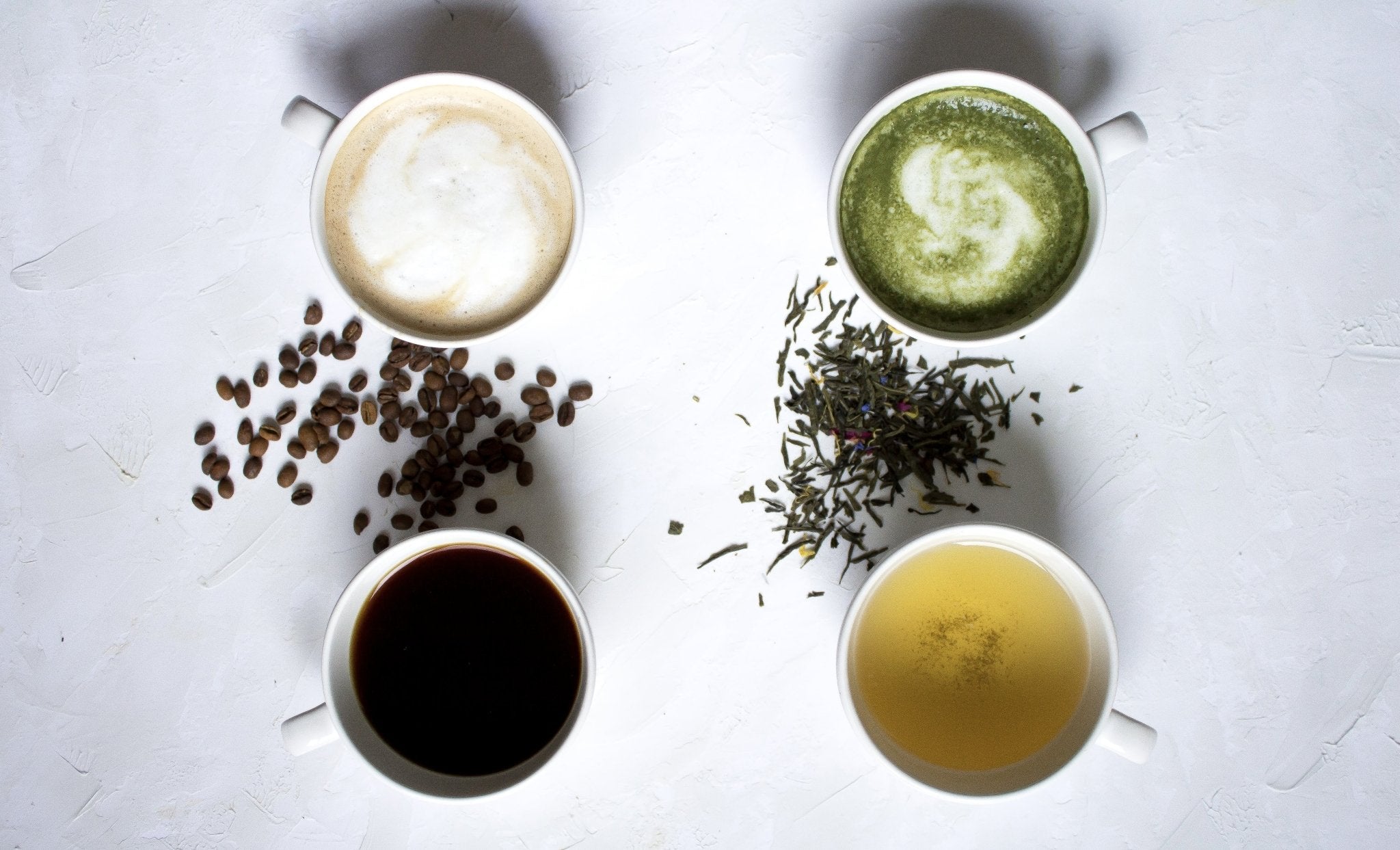 Assorted hot beverages latte-matcha-tea-coffee (clock wise from top left)