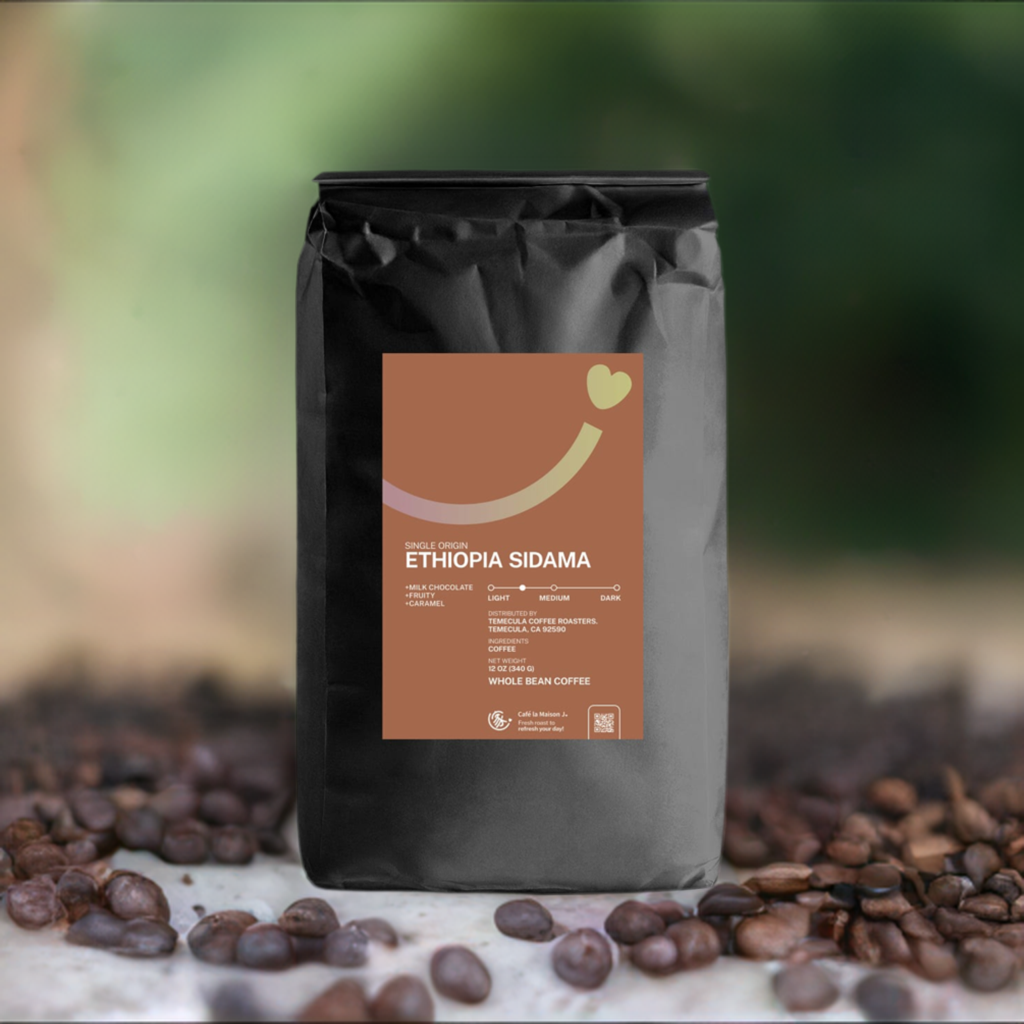 a bag of 12oz single origin Ethiopia Sidama coffee bean with blur natural landscape backdrop and some roasted coffee beans on the ground