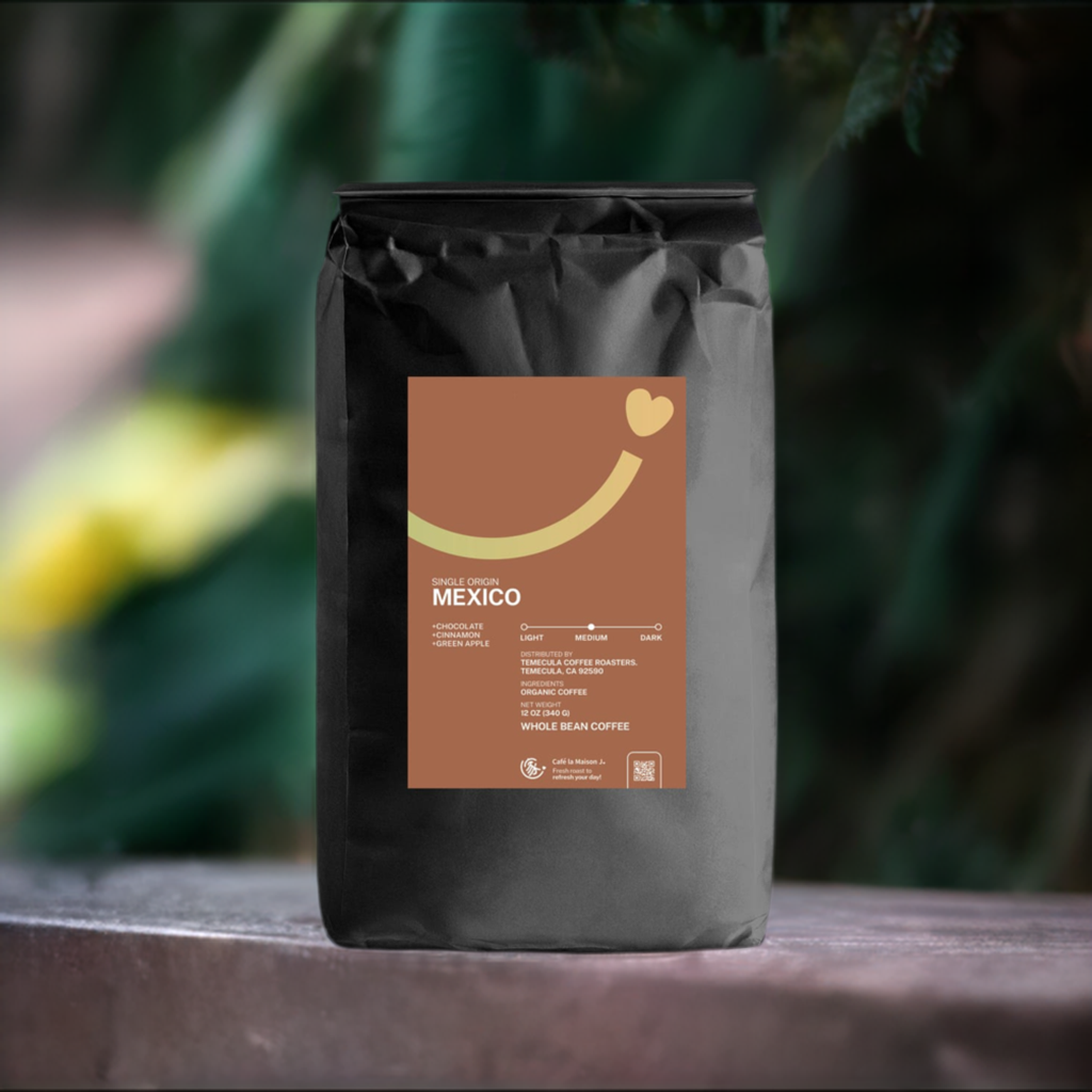 a bag of organic single origin Mexico on ground with green and yellow natural tree backdrop