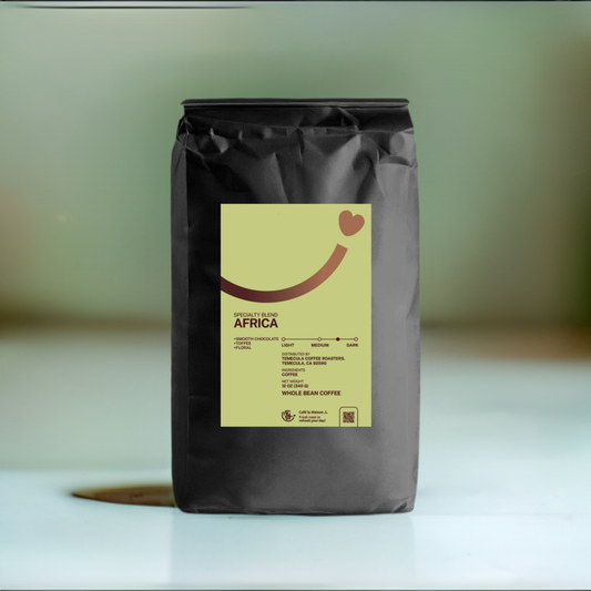 A bag of 12oz medium/dark roast specialty coffee  blend coffee, the label is green coler with a gradient brown color smiley line and a heart shape at the uper right corner to end the smiley line. the background of the image is gradient green color.