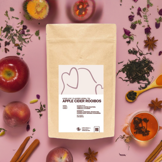 A bag of loose leaf Apple Cider Rooibos surrounded with fruits, cinnamon, loose leaf tea