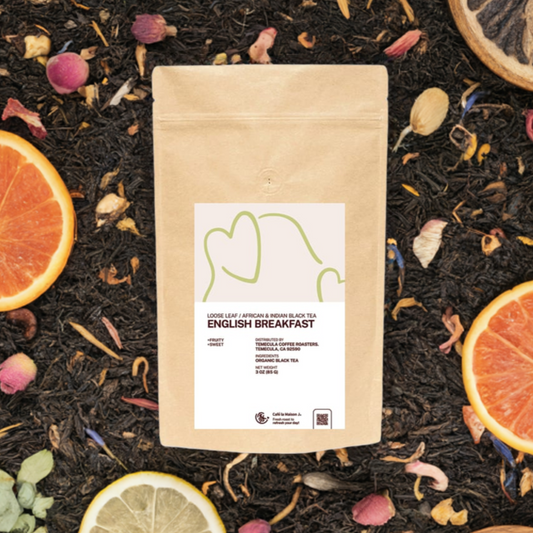 A Bag of Organic Loose Leaf Indian and African Black Tea Surrounded with Tea Leaf, Orange Peel, Rose Buds