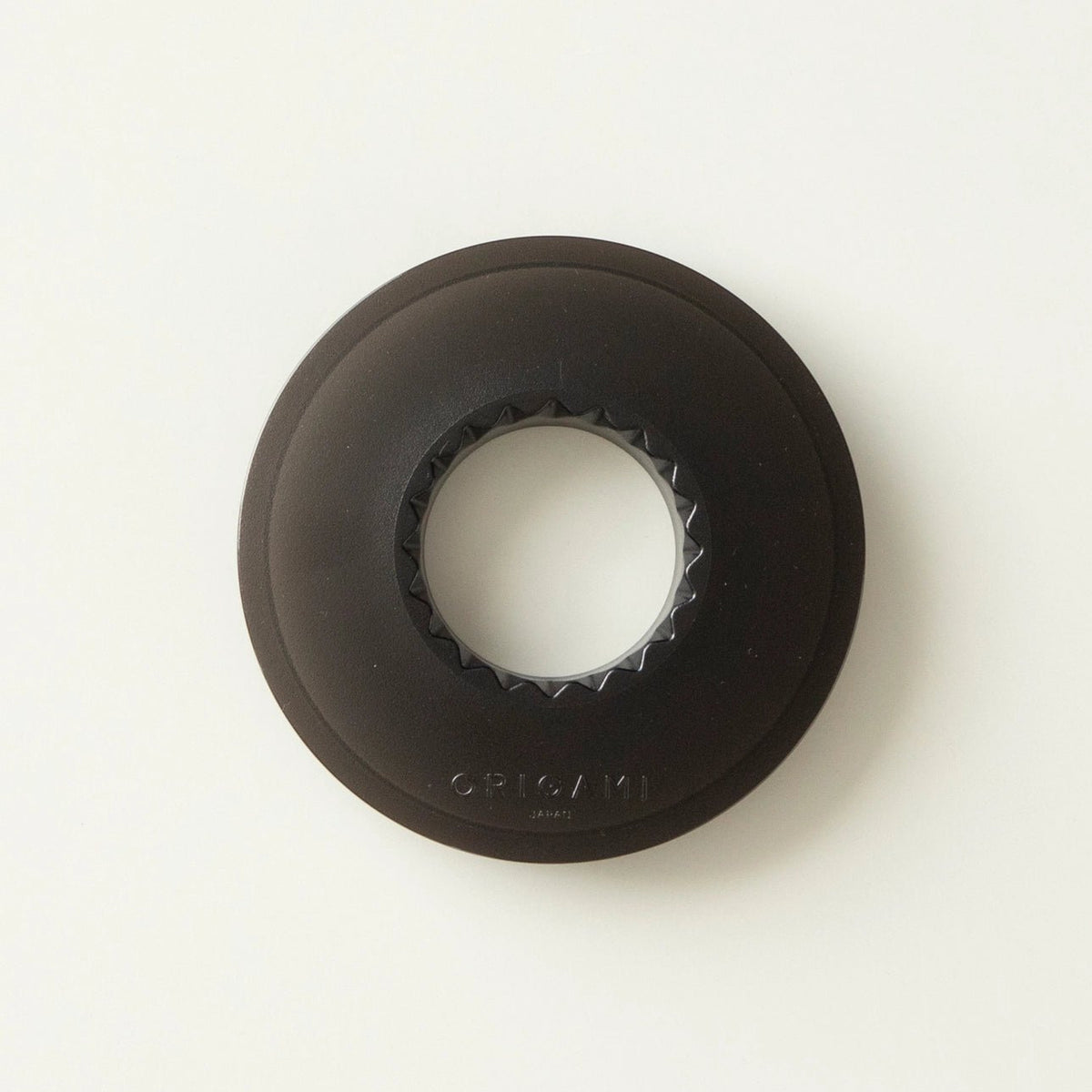 A black circular AS Resin dripper holder with a textured inner edge and the brand name 'ORIGAMI' embossed near the bottom, shown on a clean white background.