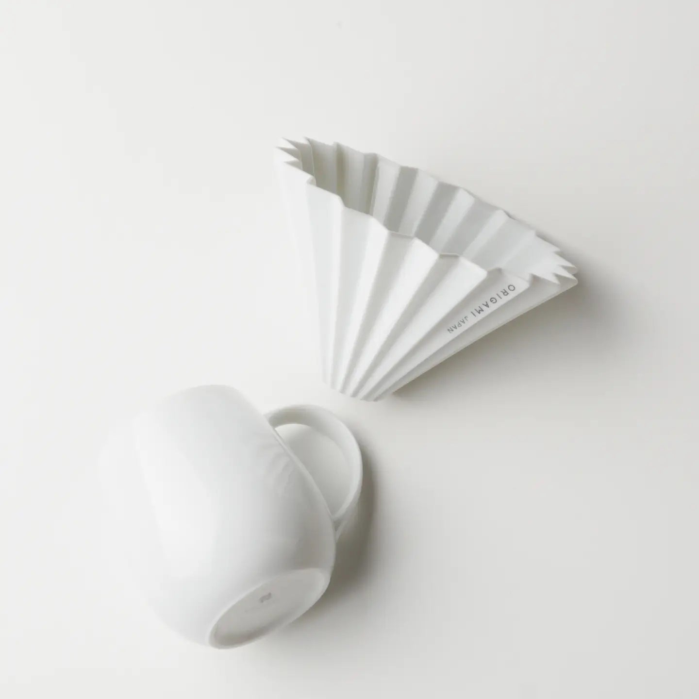A white ORIGAMI Barrel Aroma Mug and a matching white porcelain ORIGAMI Coffee Dripper